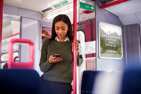 Young woman using a phone on a train